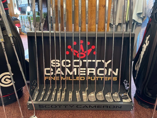 A display of scotty cameron golf clubs.